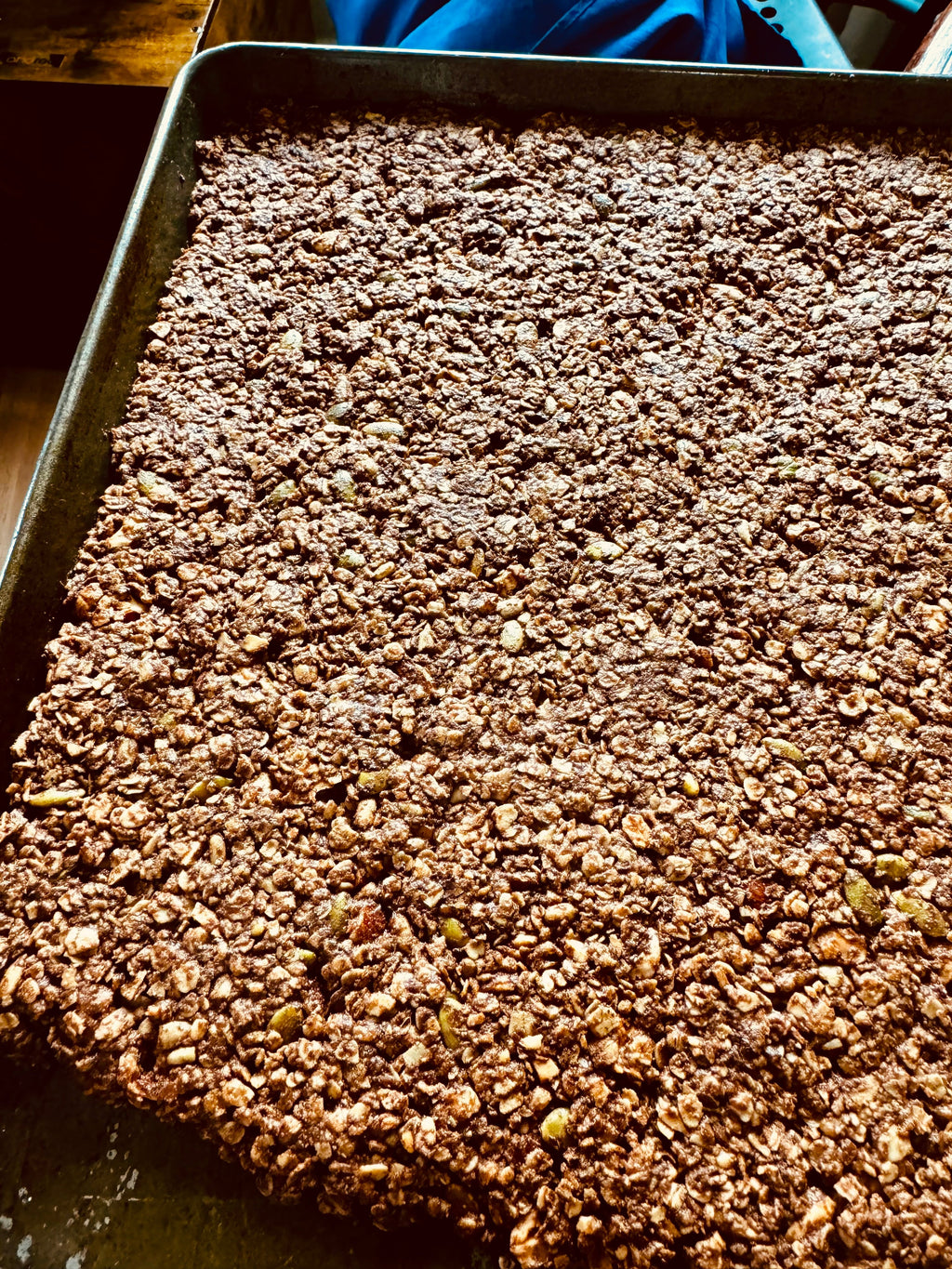 Deep Forest Granola spread across a baking pan
