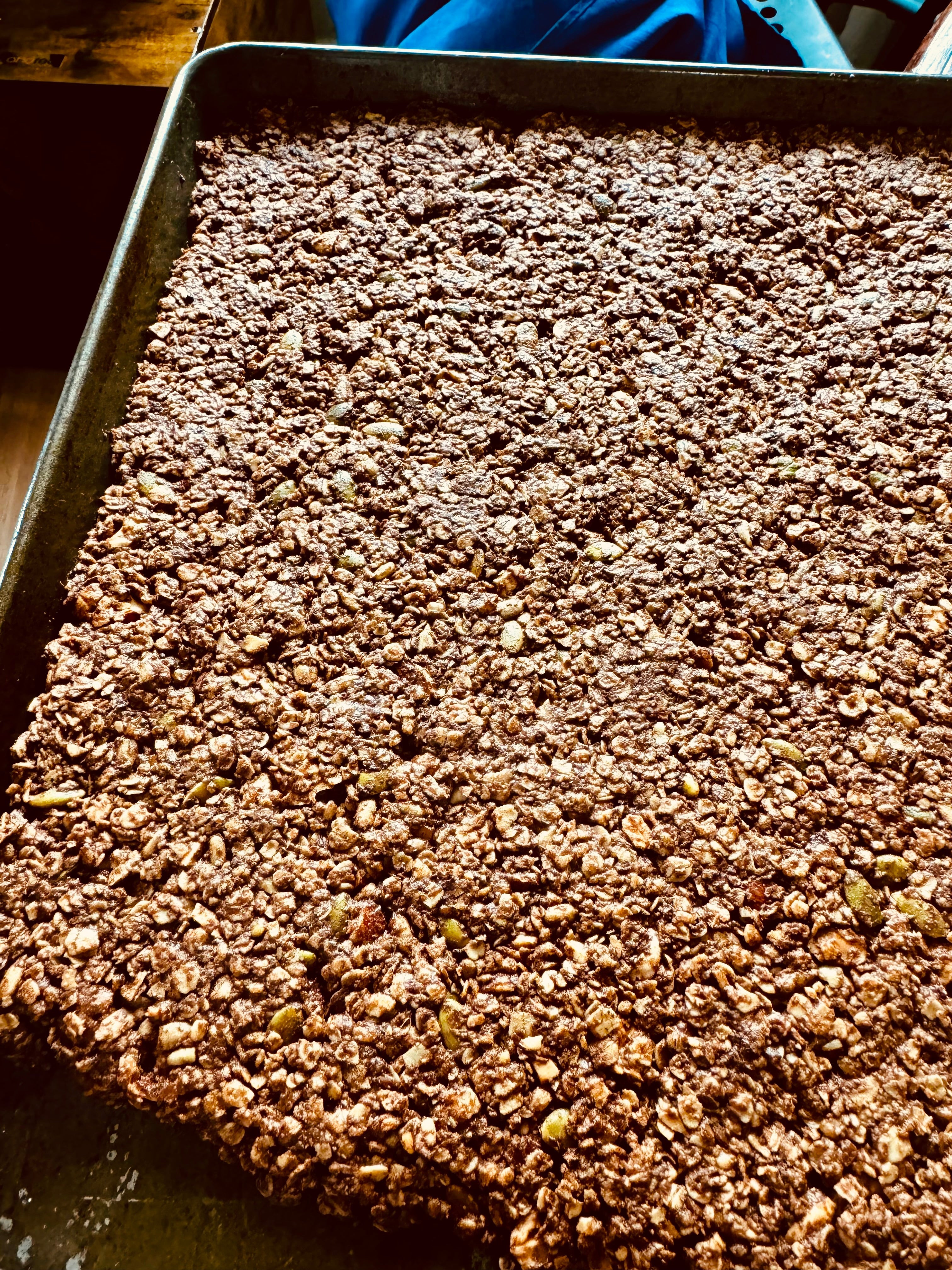Deep Forest Granola spread across a baking pan